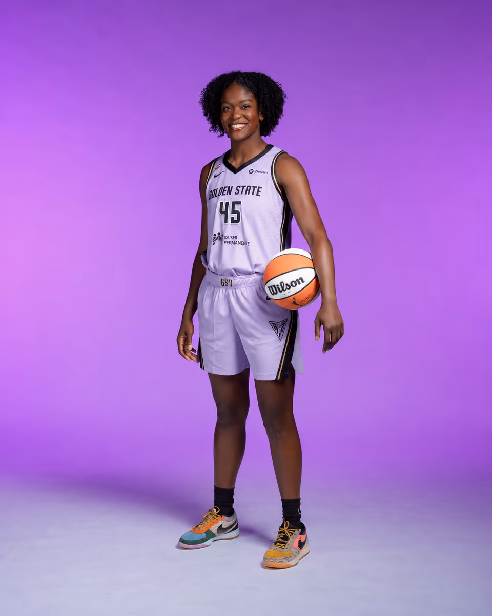 Nadia Fingall poses with a basketball in a Golden State Valkyries uniform