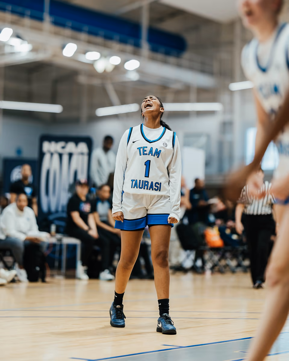 A young basketball player reacts with emotion during competition.