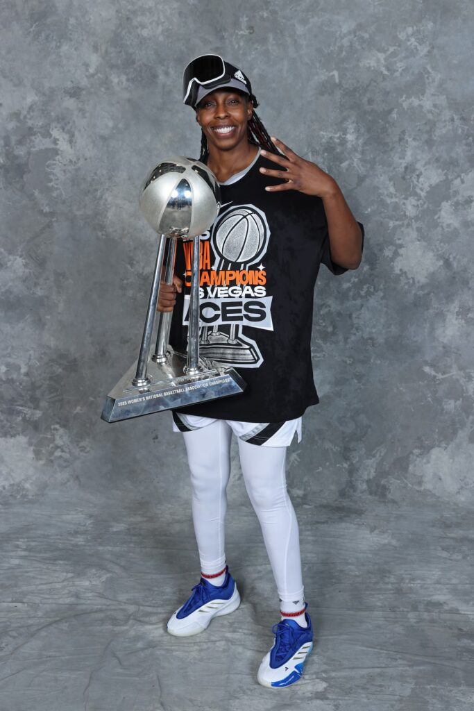 Chelsea Gray holding the 2016 WNBA championship trophy